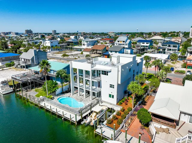 a kitchen with granite countertop white cabinets white appliances a sink and a window