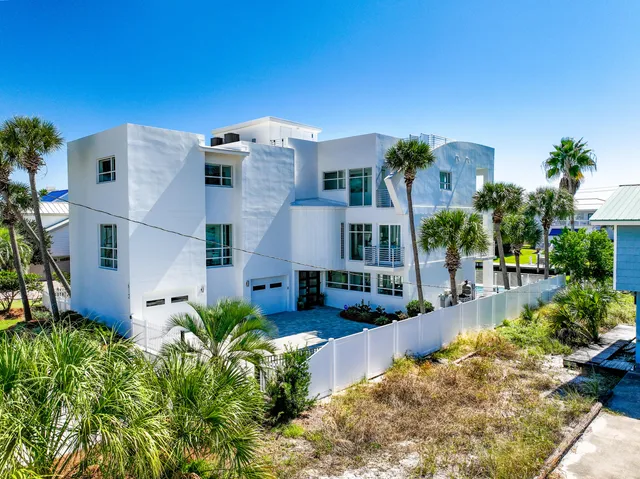 a living room with wooden floor and large window