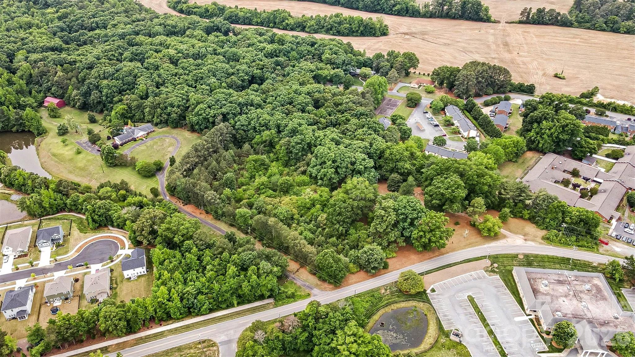 1116 Medlin Road Monroe, NC 28112 - Photo 32 of 40 an aerial view of a house with a yard and lake view