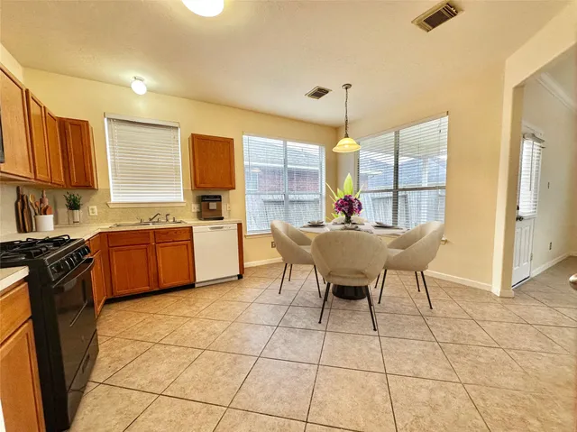 a kitchen with a sink cabinets and window