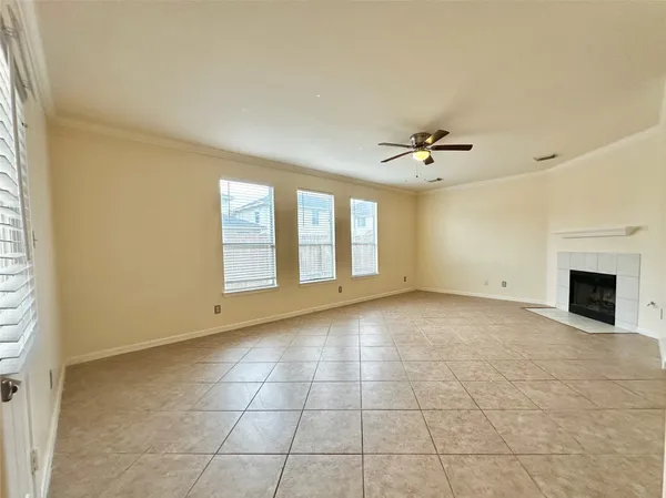 a view of an empty room with a fireplace and a window