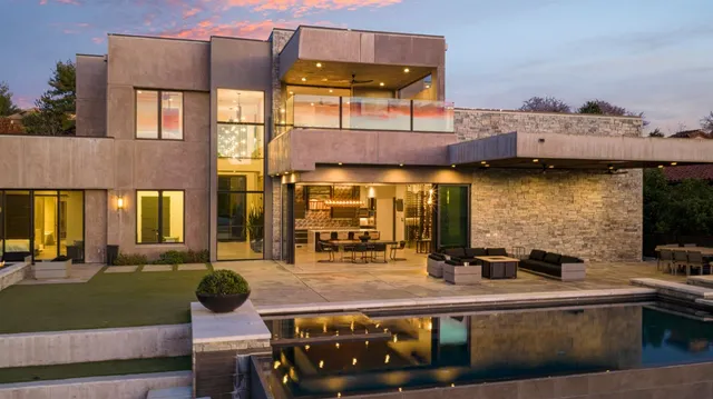 a kitchen with stainless steel appliances kitchen island granite countertop a table chairs cabinets and wooden floor