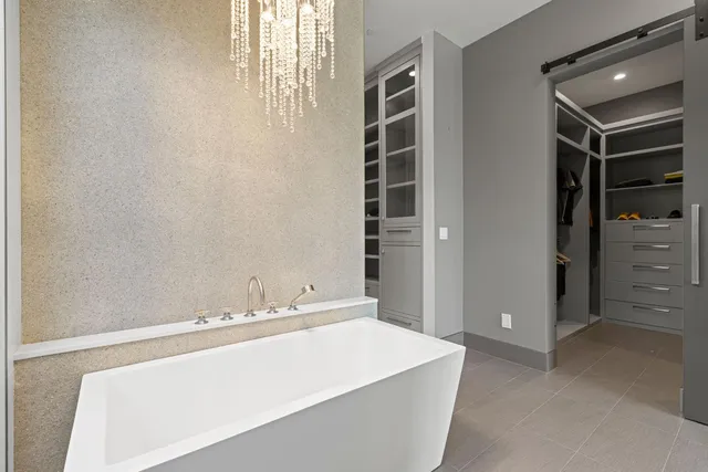 a front view of a building with swimming pool and seating space