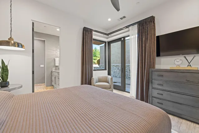 a dining hall with stainless steel appliances kitchen island granite countertop a table chairs and a refrigerator