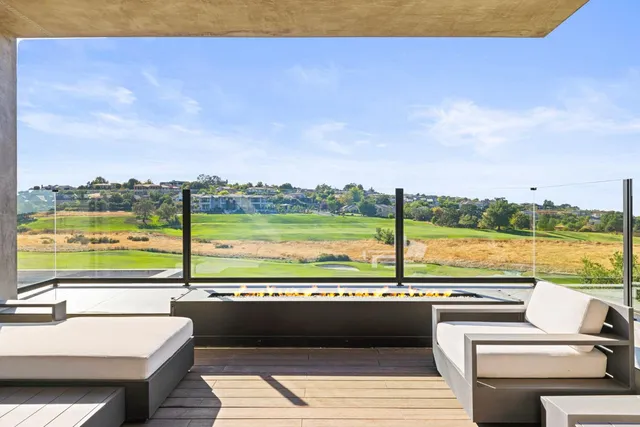 an aerial view of residential houses with outdoor space