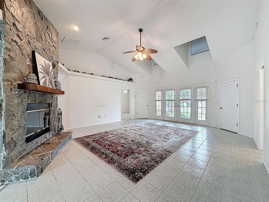 9545 Montebello Lane Spring Hill, FL 34608 - Photo 11 of 74 a living room with hard wood floor and a fireplace