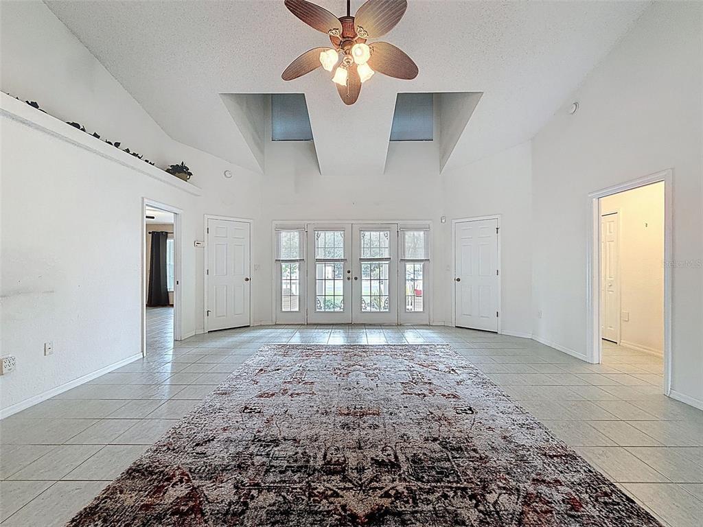 9545 Montebello Lane Spring Hill, FL 34608 - Photo 13 of 74 a view of an empty room with window and chandelier fan