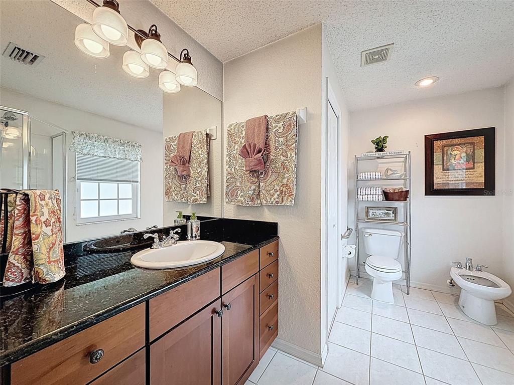 9545 Montebello Lane Spring Hill, FL 34608 - Photo 31 of 74 a bathroom with a sink a toilet and a large mirror