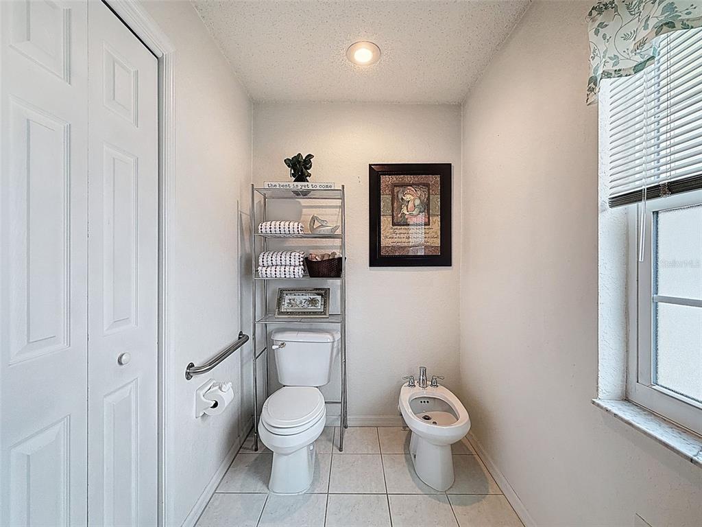 9545 Montebello Lane Spring Hill, FL 34608 - Photo 32 of 74 a bathroom with a toilet a sink and a window