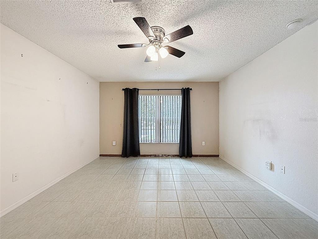 9545 Montebello Lane Spring Hill, FL 34608 - Photo 48 of 74 a view of an empty room with chandelier fan and window