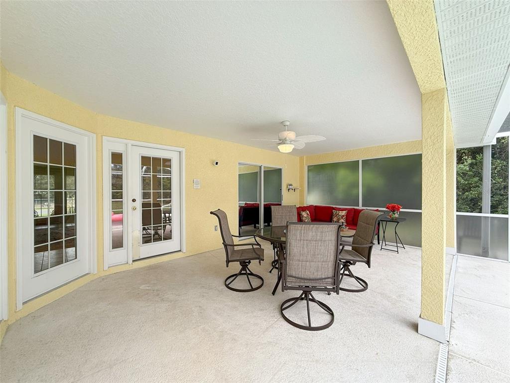 9545 Montebello Lane Spring Hill, FL 34608 - Photo 49 of 74 a dining room with furniture and a floor to ceiling window