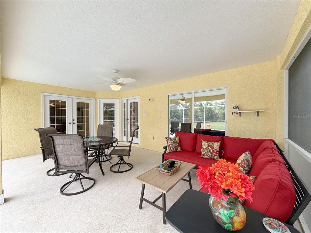9545 Montebello Lane Spring Hill, FL 34608 - Photo 50 of 74 a living room with furniture and floor to ceiling windows