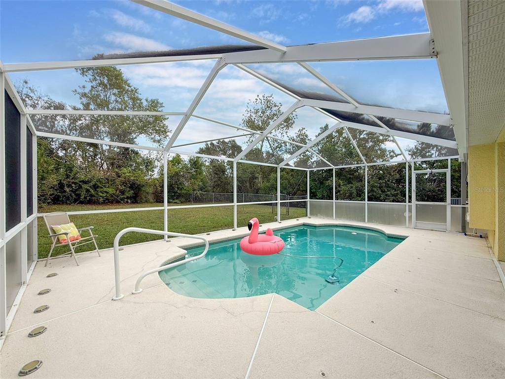 9545 Montebello Lane Spring Hill, FL 34608 - Photo 52 of 74 a view of a house with a backyard porch and sitting area
