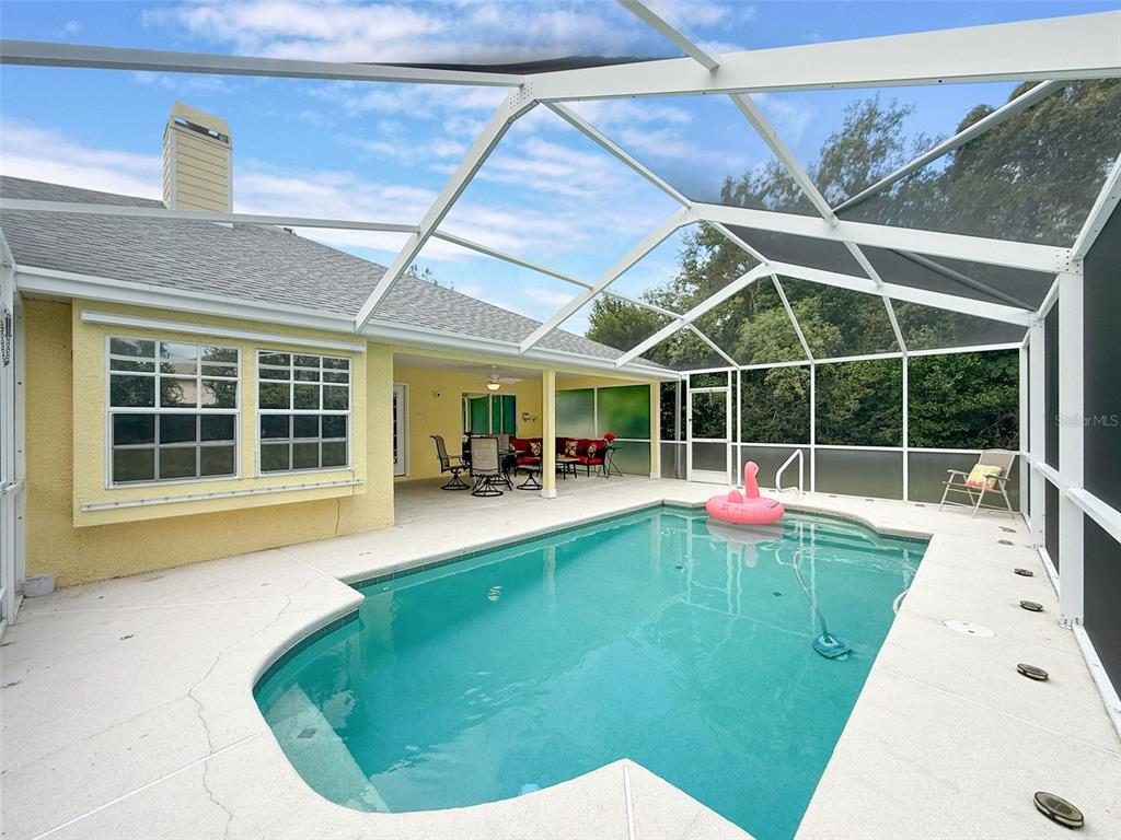 9545 Montebello Lane Spring Hill, FL 34608 - Photo 56 of 74 a view of a house with backyard sitting area and porch