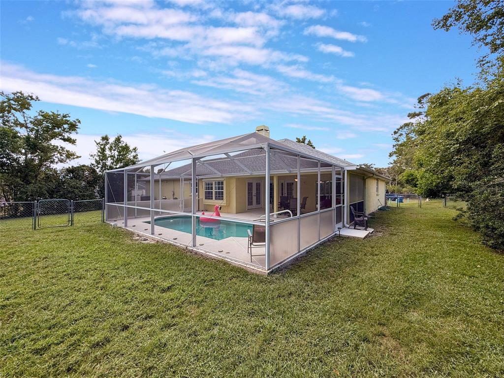 9545 Montebello Lane Spring Hill, FL 34608 - Photo 58 of 74 a view of a house with a yard and sitting area