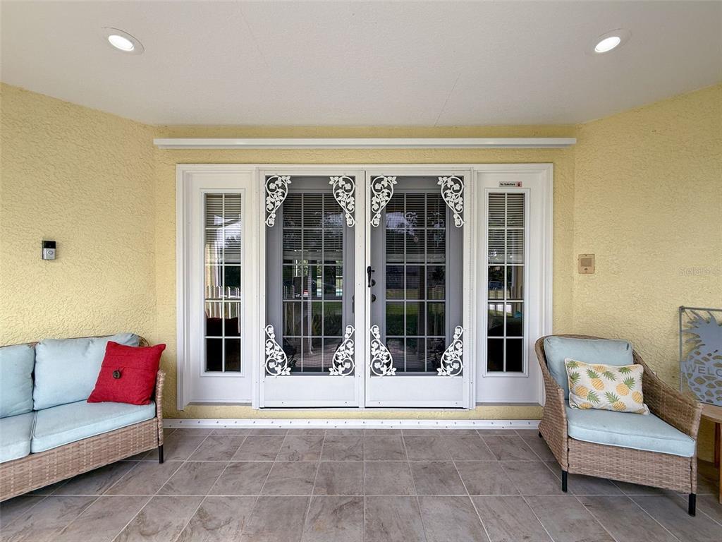 9545 Montebello Lane Spring Hill, FL 34608 - Photo 6 of 74 a living room with furniture and a floor to ceiling window