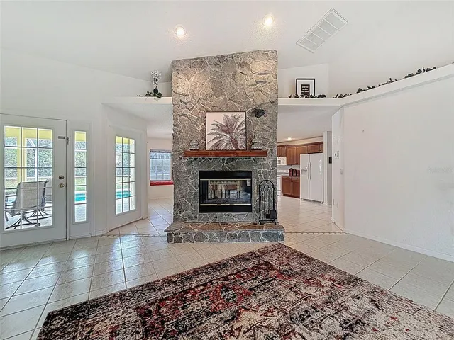 a kitchen with stainless steel appliances a stove a sink a dining table and chairs