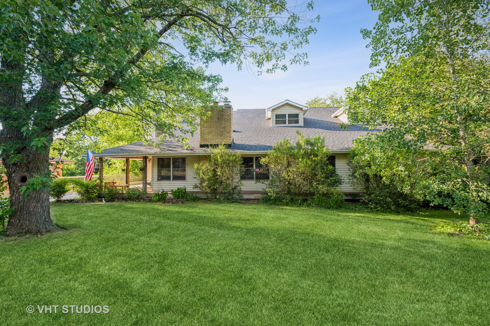 a front view of a house with a garden
