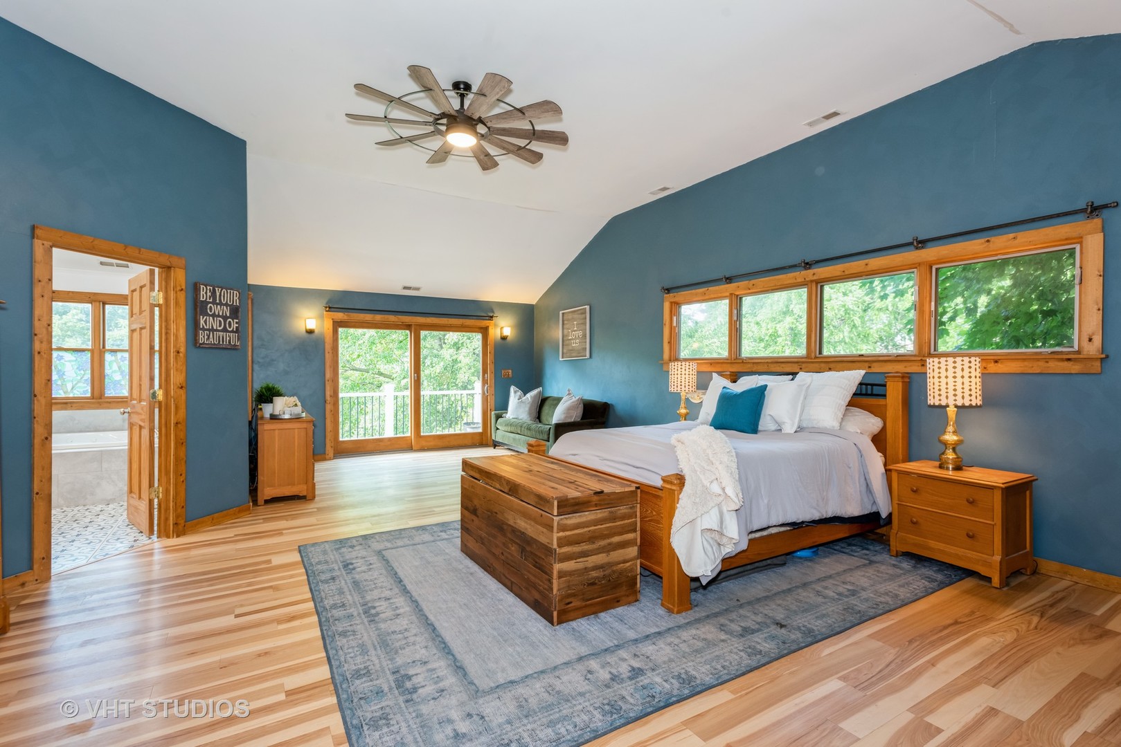 708 Riedy Road Lisle, IL 60532 - Photo 18 of 25 a spacious bedroom with a large bed a chandelier and windows
