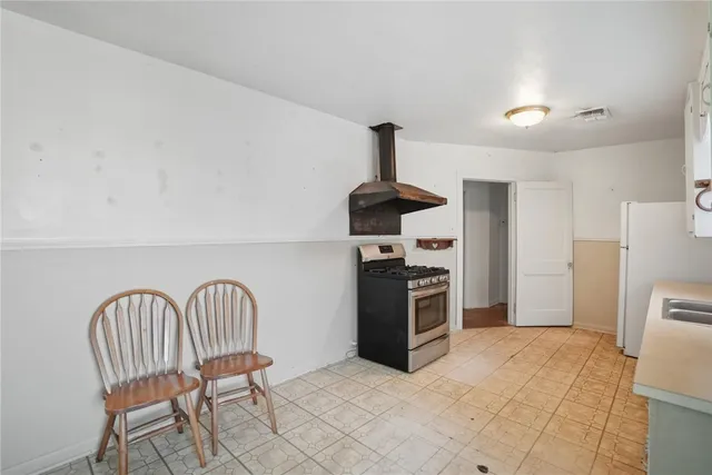 a kitchen with stainless steel appliances a refrigerator and a stove top oven