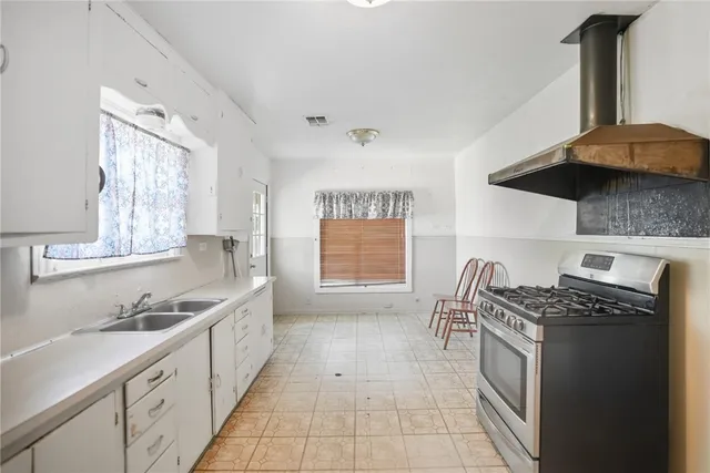 a kitchen with stainless steel appliances granite countertop a sink stove and cabinets