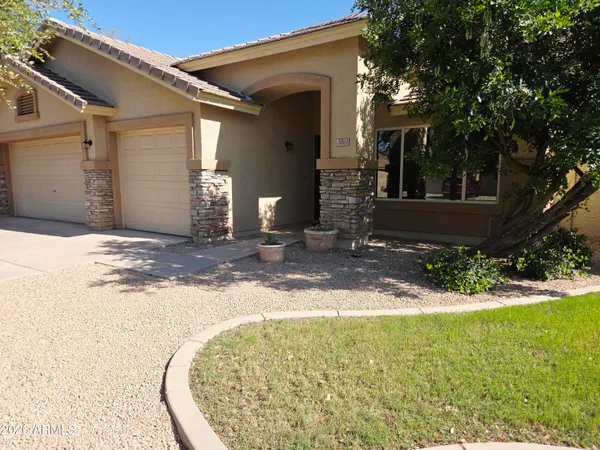 a view of a house with backyard and a tree