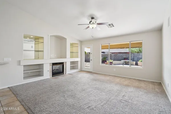 an empty room with windows and entrance