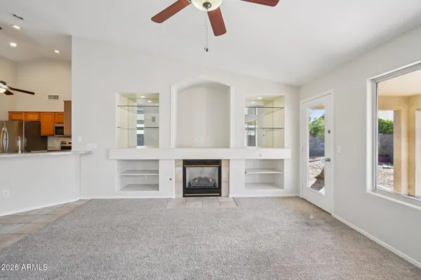 a view of a livingroom with an empty space and a fireplace