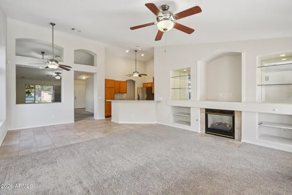wooden floor fireplace and windows in an empty room
