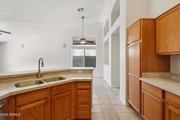 a kitchen with stainless steel appliances granite countertop a sink refrigerator and cabinets