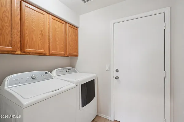 a kitchen with stainless steel appliances granite countertop a sink a refrigerator and a wooden cabinets
