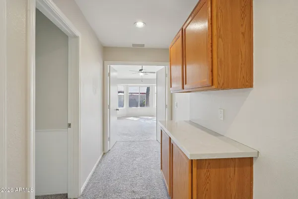a bathroom with a granite countertop toilet sink and mirror