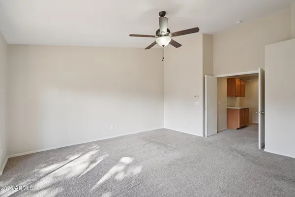 a view of a livingroom with a ceiling fan and window