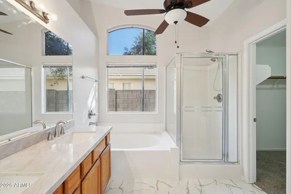 a bathroom with a tub sink and mirror