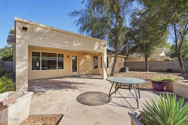 a view of a house with backyard and sitting area