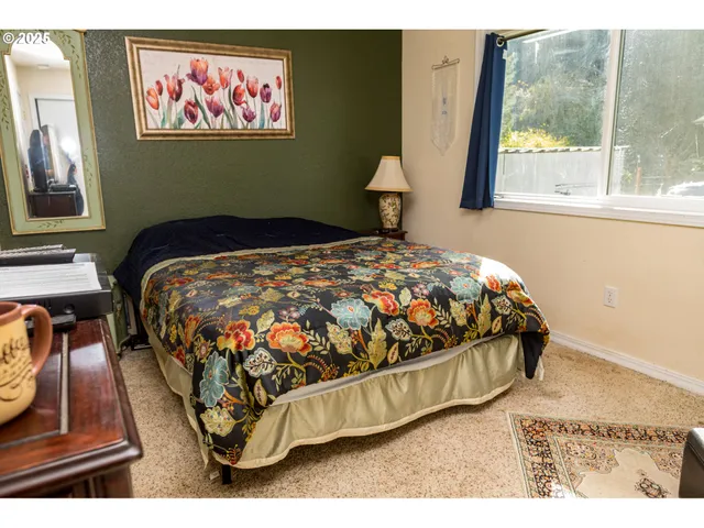 a bedroom with a large bed and a window