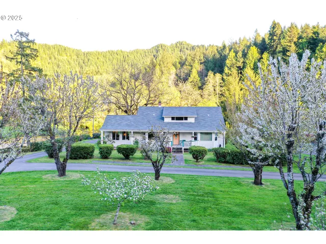 a dining room with furniture a chandelier and wooden floor
