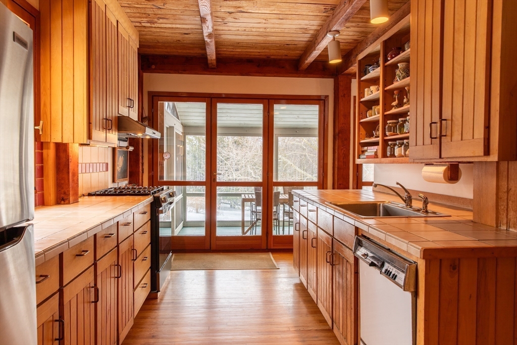 45 Sessions Road Hardwick, MA 01037 - Photo 10 of 28 a kitchen with stainless steel appliances granite countertop a stove a sink and a refrigerator