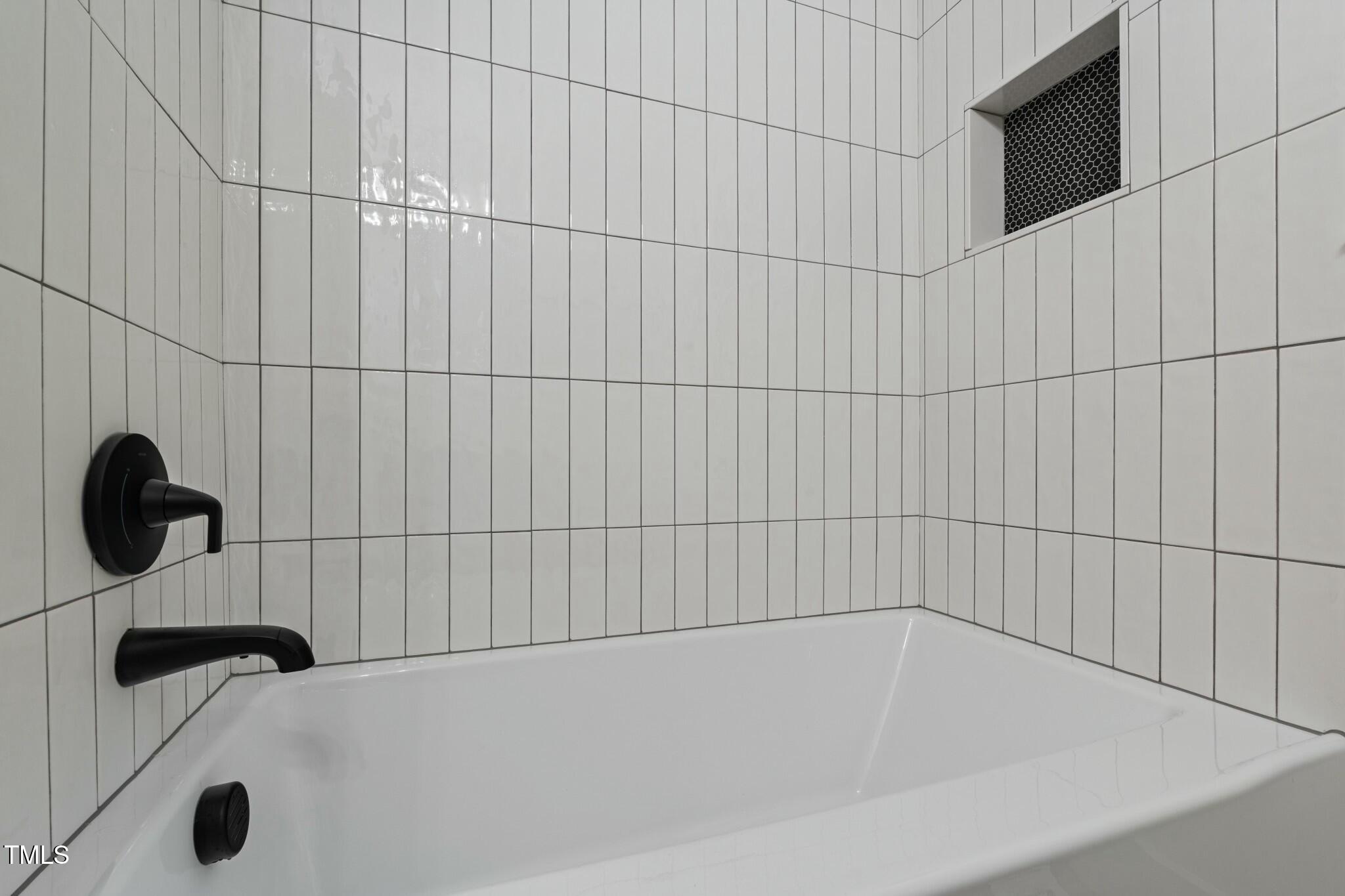 6421 Arrington Road Raleigh, NC 27607 - Photo 18 of 31 a bathroom with a bathtub