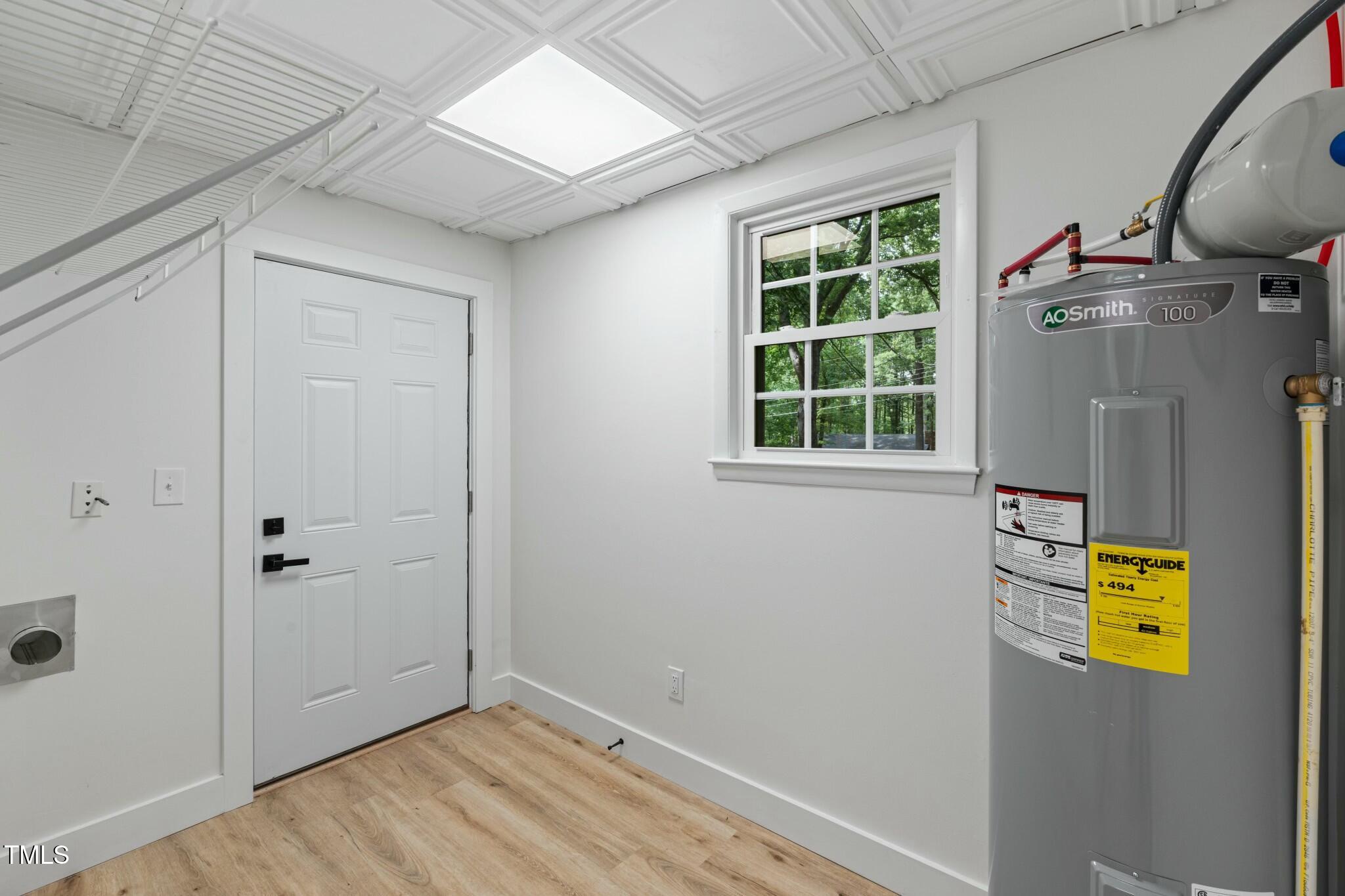 6421 Arrington Road Raleigh, NC 27607 - Photo 22 of 31 a view of empty room with window and wooden floor