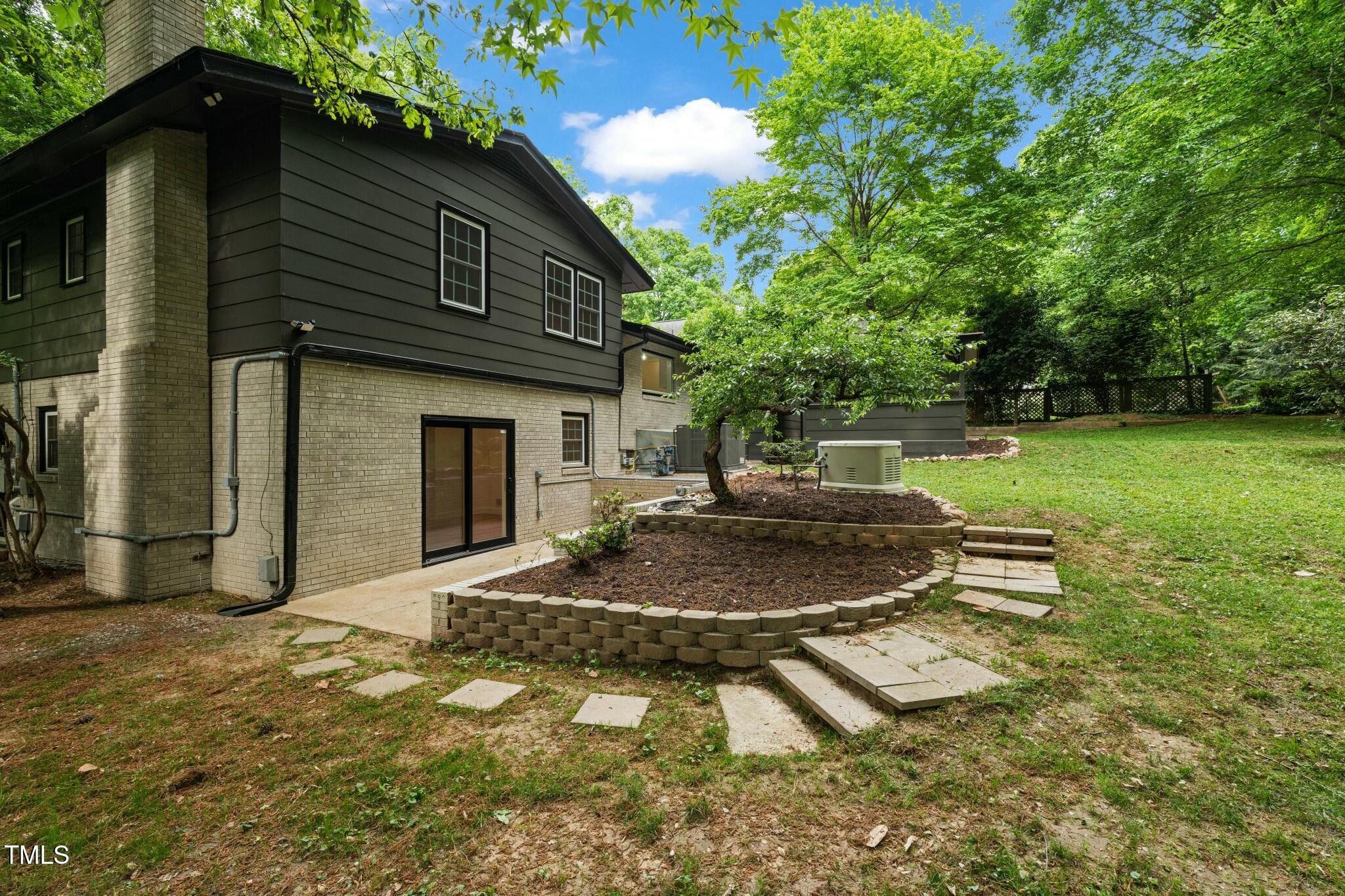 6421 Arrington Road Raleigh, NC 27607 - Photo 26 of 31 a backyard of a house with outdoor seating
