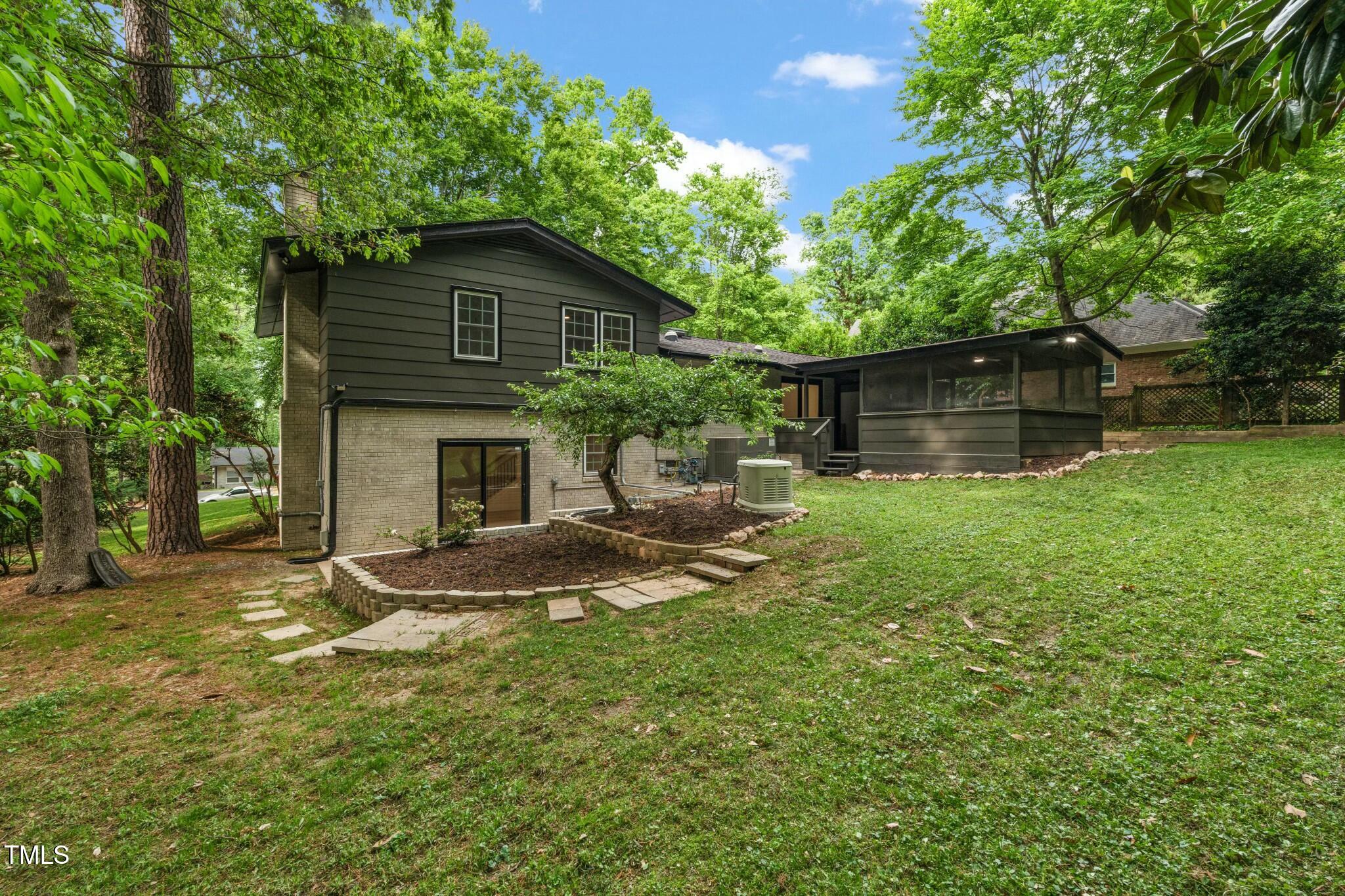 6421 Arrington Road Raleigh, NC 27607 - Photo 28 of 31 a view of a house with backyard and sitting area