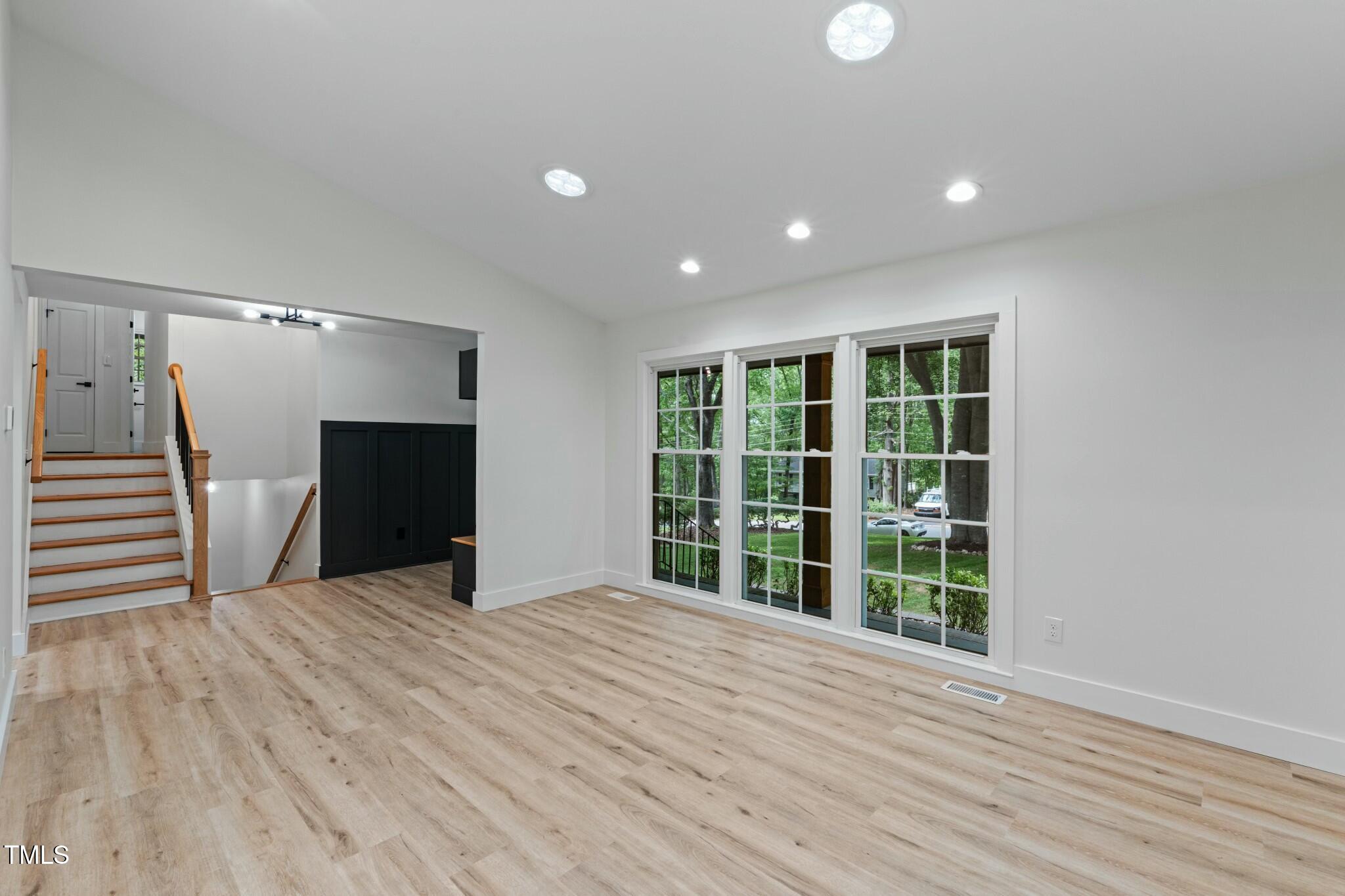6421 Arrington Road Raleigh, NC 27607 - Photo 8 of 31 a view of an empty room with wooden floor and a window