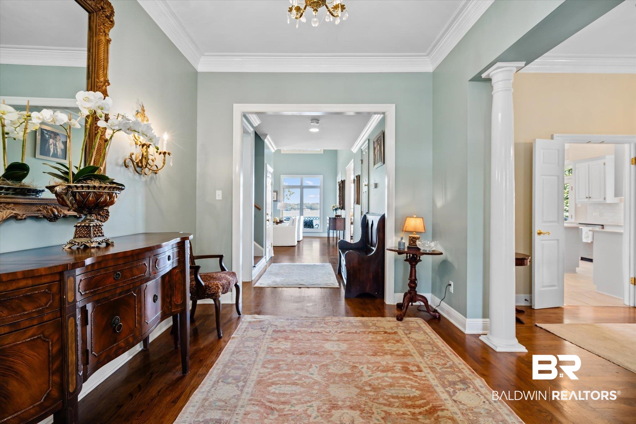 4930 River Trace Theodore, AL 36582 - Photo 4 of 57 Hallway with decorative columns, crown molding, and wood-type flooring