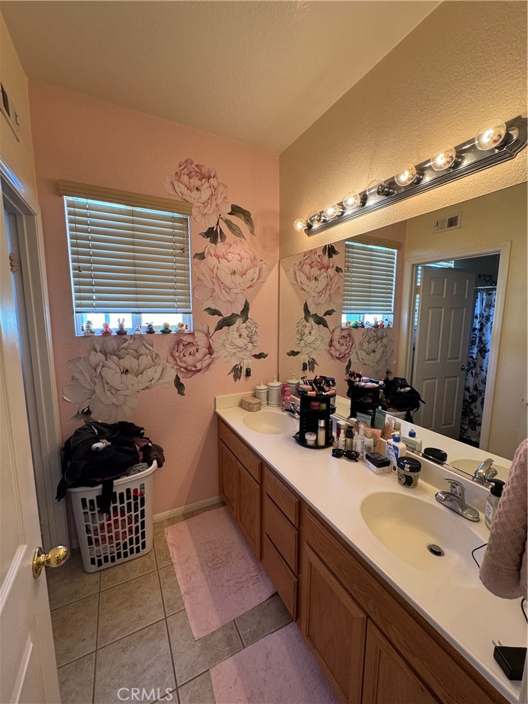 12203 Appian Drive Rancho Cucamonga, CA 91739 - Photo 17 of 20 a bathroom with a sink and a mirror