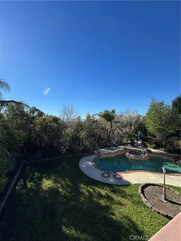 a view of a swimming pool with a yard