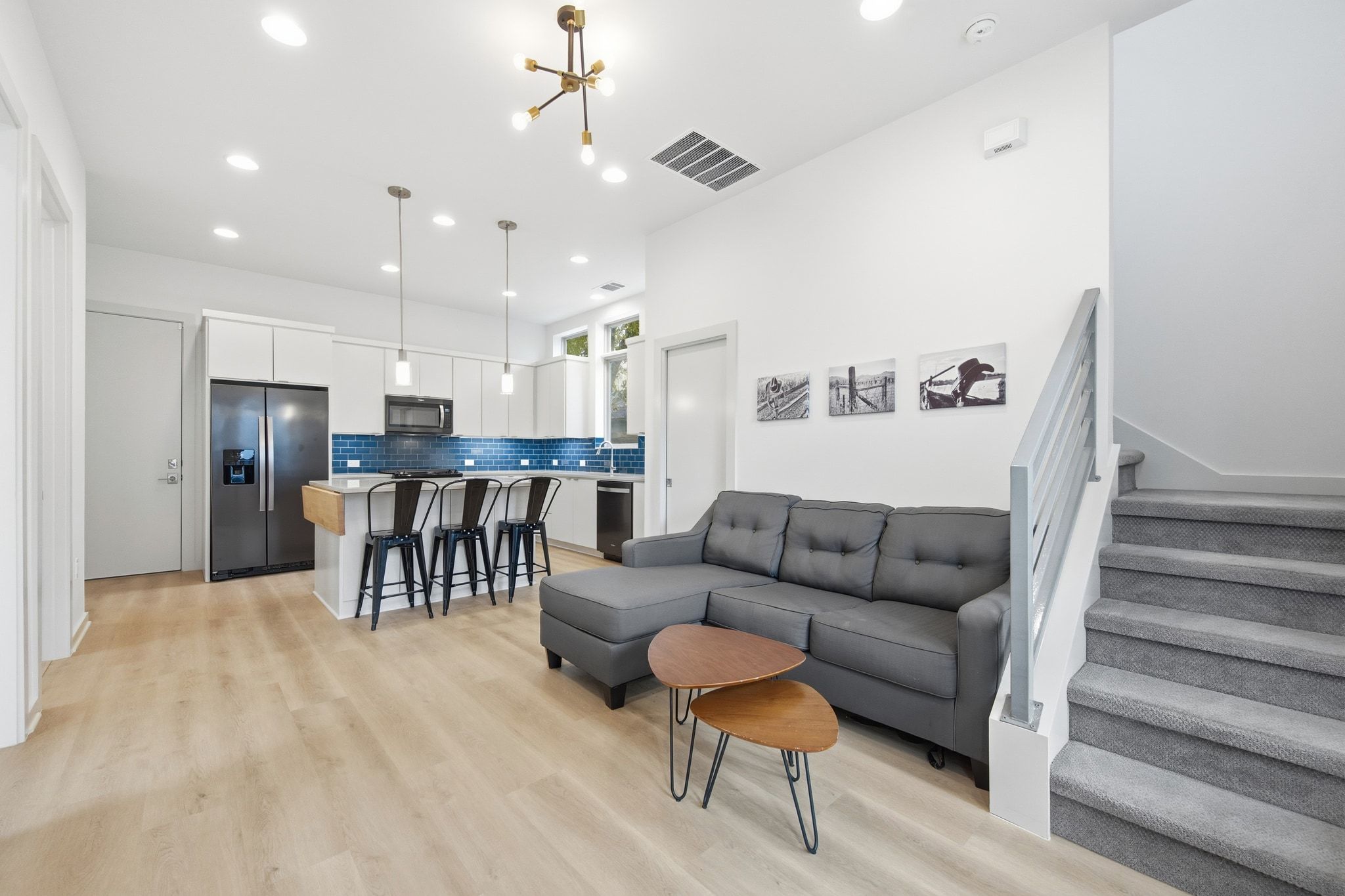 2811 Garwood Street, Unit B Austin, TX 78702 - Photo 5 of 24 Living area with light wood-type flooring, stairs, recessed lighting, and a chandelier