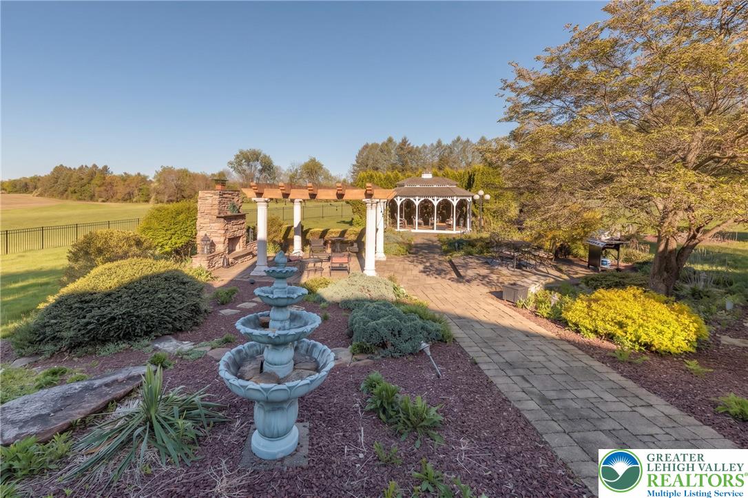1089 Deemer Road Bath, PA 18014 - Photo 11 of 57 This tranquil outdoor retreat offers a charming gazebo, fountain, and spacious patio.
