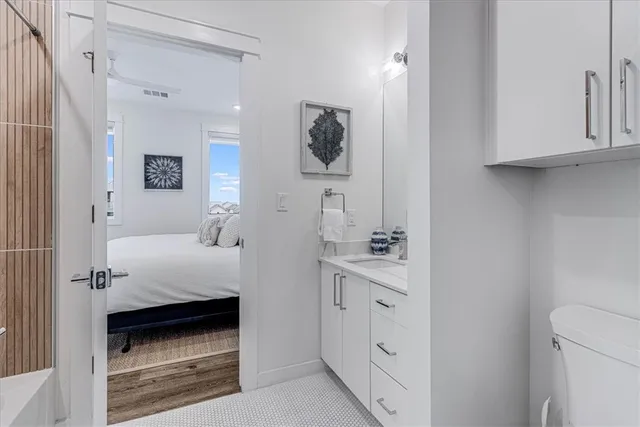 a en suite bathroom with a toilet sink and mirror