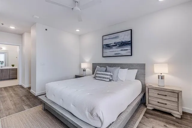 a living room with a bed and a chair